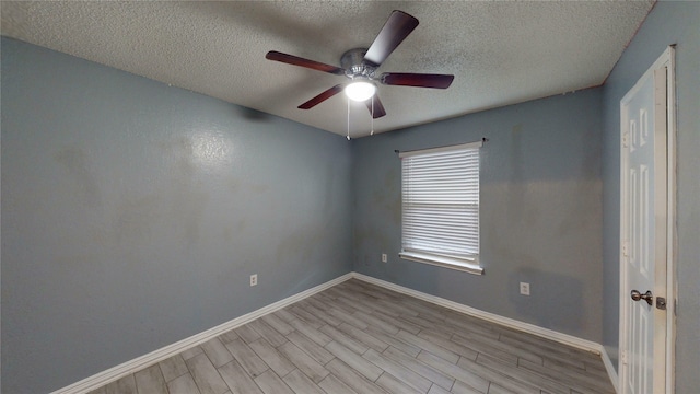 928 Thistle Ridge Ln, Arlington, TX 76017 - empty room featuring a textured ceiling, ceiling fan, baseboards, and wood finished floors