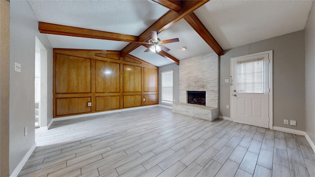 928 Thistle Ridge Ln, Arlington, TX 76017 - unfurnished living room featuring a fireplace, ceiling fan, baseboards, light wood-style flooring, and a textured ceiling
