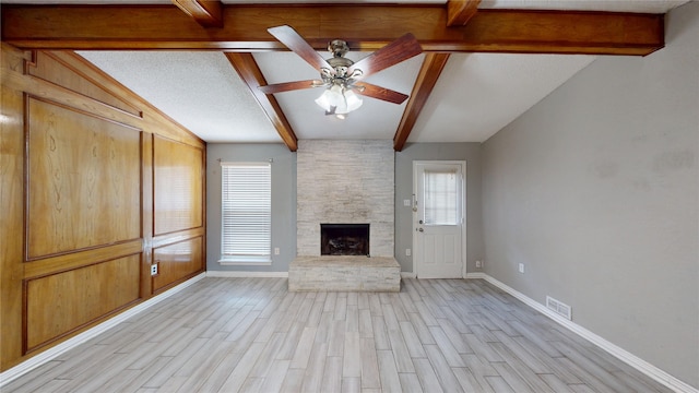 928 Thistle Ridge Ln, Arlington, TX 76017 - unfurnished living room with baseboards, light wood finished floors, a ceiling fan, and a stone fireplace