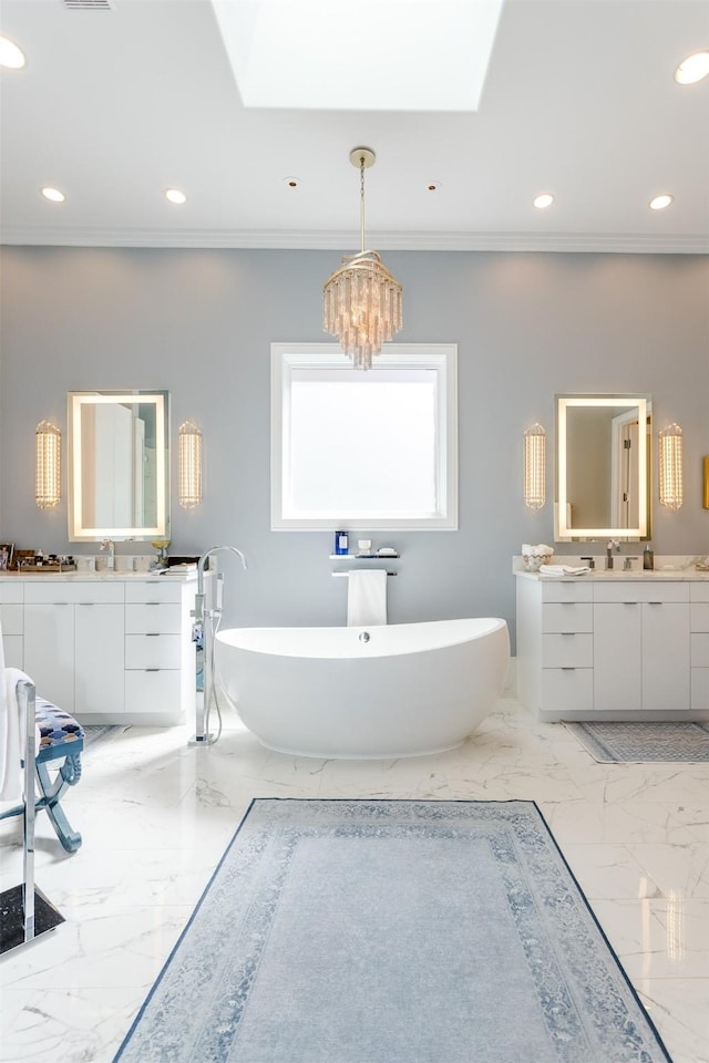 6406 Glendora Ave, Dallas, TX 75230 - full bath with two vanities, marble tiled floors, a freestanding bath, a chandelier, and crown molding
