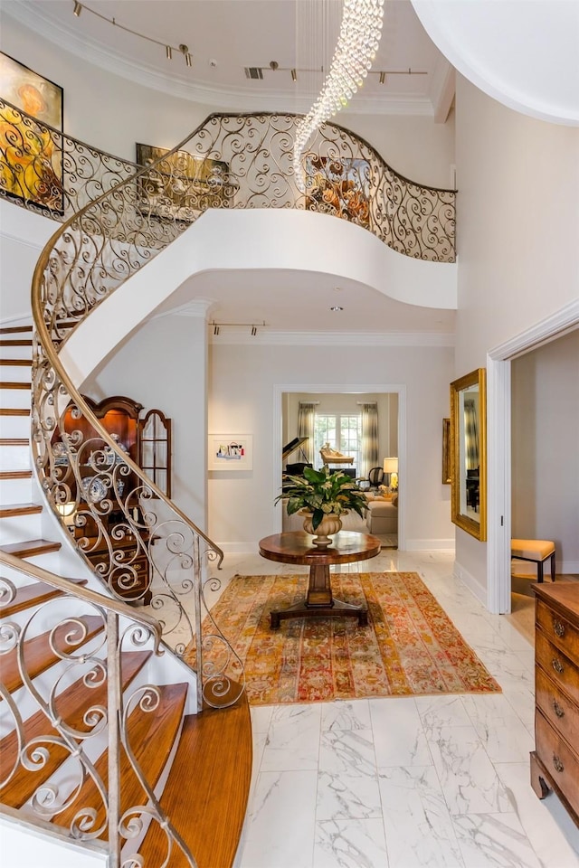 6406 Glendora Ave, Dallas, TX 75230 - entrance foyer featuring marble finish floors, crown molding, stairway, a towering ceiling, and baseboards