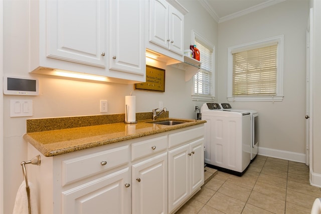 6406 Glendora Ave, Dallas, TX 75230 - laundry room with washer and dryer, ornamental molding, light tile patterned floors, cabinet space, and baseboards