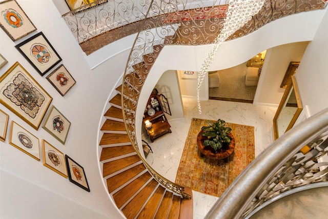 6406 Glendora Ave, Dallas, TX 75230 - stairs with arched walkways, marble finish floors, and baseboards