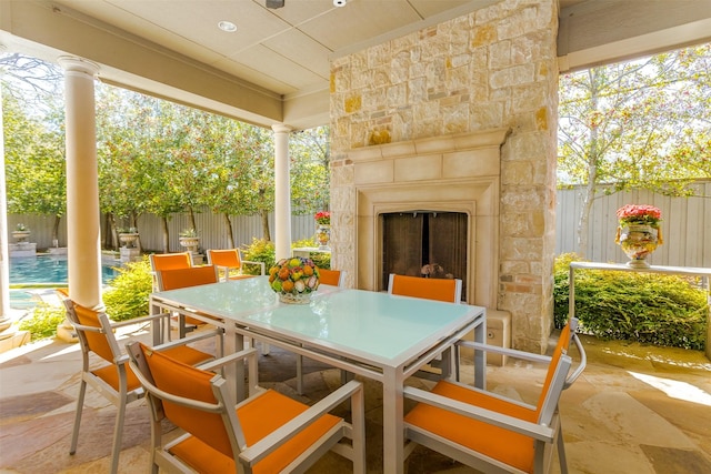 6406 Glendora Ave, Dallas, TX 75230 - view of patio / terrace featuring an outdoor stone fireplace, outdoor dining area, and a ceiling fan