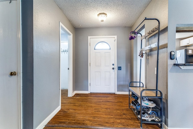 3808 River Birch Rd, Fort Worth, TX 76137 - entryway with wood finished floors, a textured ceiling, baseboards, and a textured wall