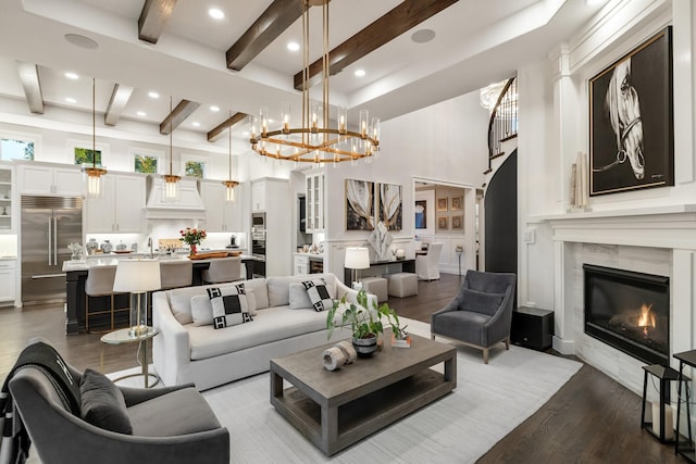 13580 Proud Clairon St, Frisco, TX 75035 - living area featuring beam ceiling, a premium fireplace, dark wood-type flooring, a chandelier, and recessed lighting