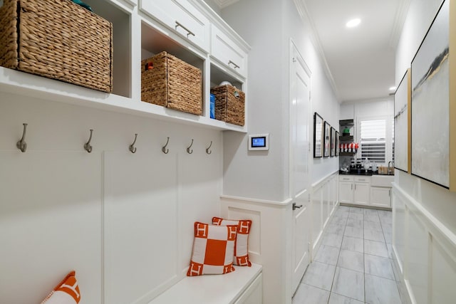 13580 Proud Clairon St, Frisco, TX 75035 - mudroom featuring crown molding, a wainscoted wall, recessed lighting, a decorative wall, and a sink