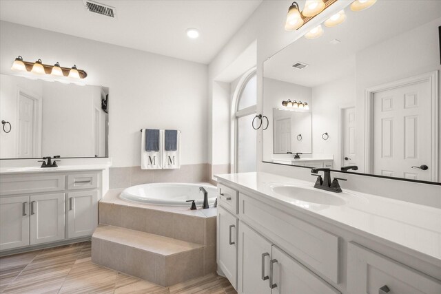 2604 Grand Colonial St, Grand Prairie, TX 75054 - full bathroom featuring two vanities, a garden tub, and recessed lighting