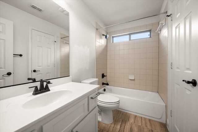 2604 Grand Colonial St, Grand Prairie, TX 75054 - bathroom featuring vanity, shower / washtub combination, toilet, and wood finished floors