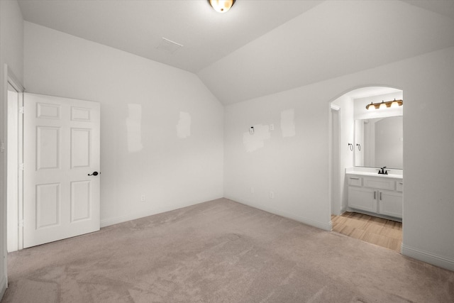 2604 Grand Colonial St, Grand Prairie, TX 75054 - additional living space with light colored carpet, vaulted ceiling, arched walkways, baseboards, and a sink