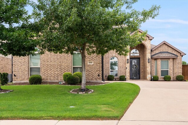 2604 Grand Colonial St, Grand Prairie, TX 75054 - view of front of property featuring brick siding, a front lawn, and driveway