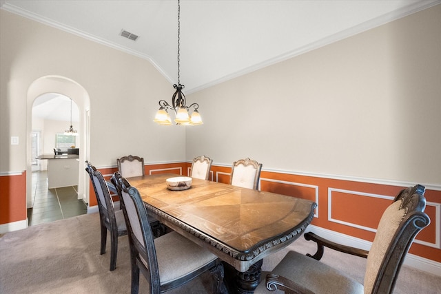 2604 Grand Colonial St, Grand Prairie, TX 75054 - dining space featuring a chandelier, crown molding, a wainscoted wall, arched walkways, and vaulted ceiling