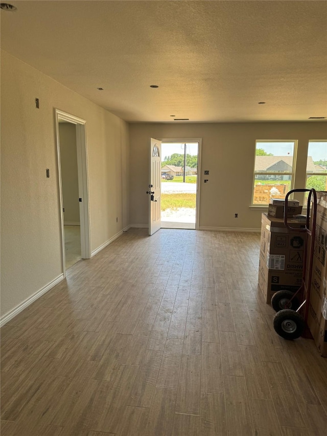 1013 Brown Ct, Poolville, TX 76487 - unfurnished living room with wood finished floors and baseboards