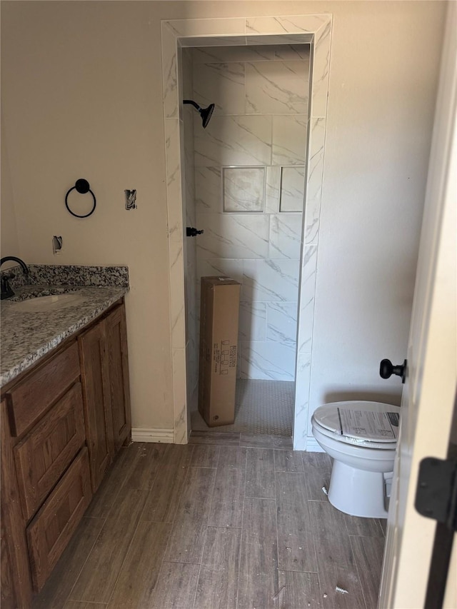 1013 Brown Ct, Poolville, TX 76487 - bathroom featuring toilet, a walk in shower, wood finished floors, and vanity