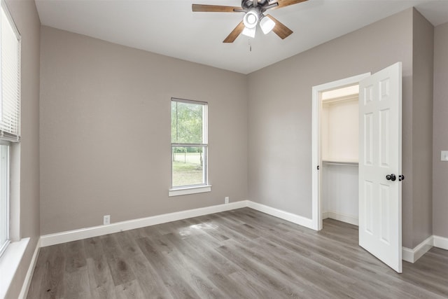322 E Division St, Muenster, TX 76252 - unfurnished bedroom featuring wood finished floors, baseboards, a closet, and a ceiling fan