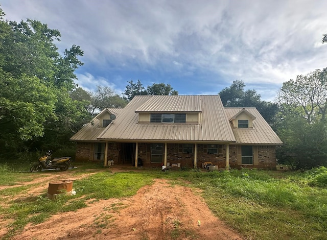 3182 E US Highway 84, Palestine, TX 75801 - view of front of house featuring brick siding, covered porch, and metal roof