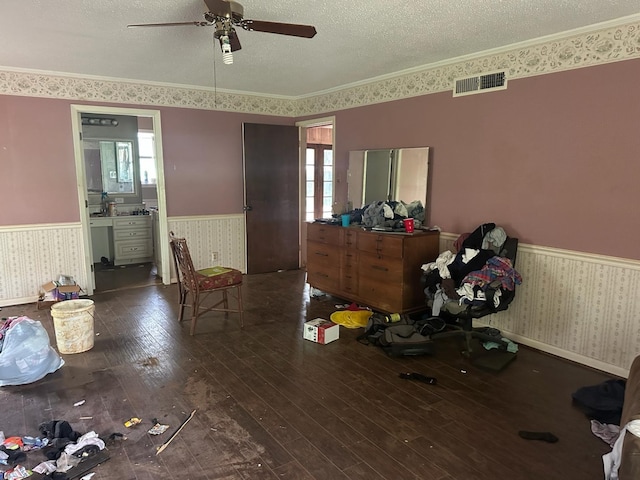 3182 E US Highway 84, Palestine, TX 75801 - bedroom with wainscoting, wallpapered walls, hardwood / wood-style flooring, a textured ceiling, and crown molding