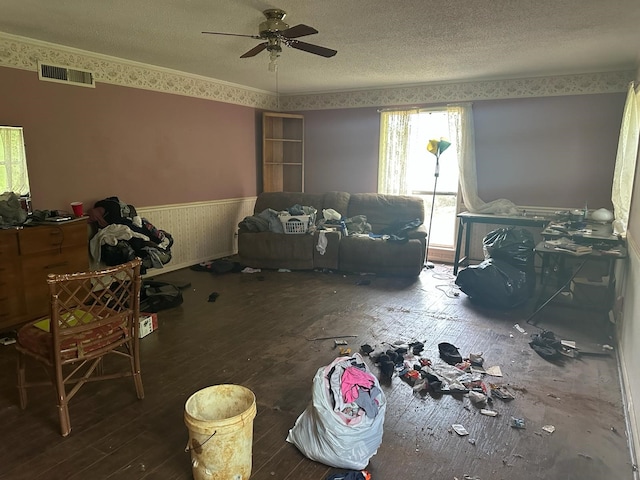 3182 E US Highway 84, Palestine, TX 75801 - living area featuring hardwood / wood-style floors, ceiling fan, a wainscoted wall, and a textured ceiling