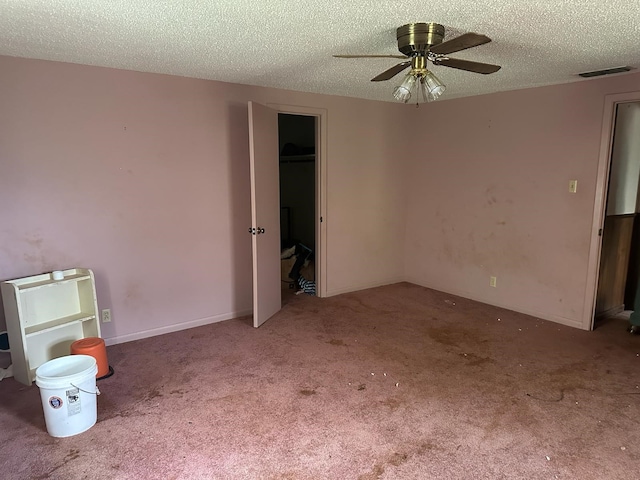 3182 E US Highway 84, Palestine, TX 75801 - spare room with a textured ceiling, carpet, and a ceiling fan