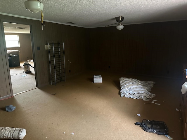 3182 E US Highway 84, Palestine, TX 75801 - empty room featuring ornamental molding, a textured ceiling, and wood walls