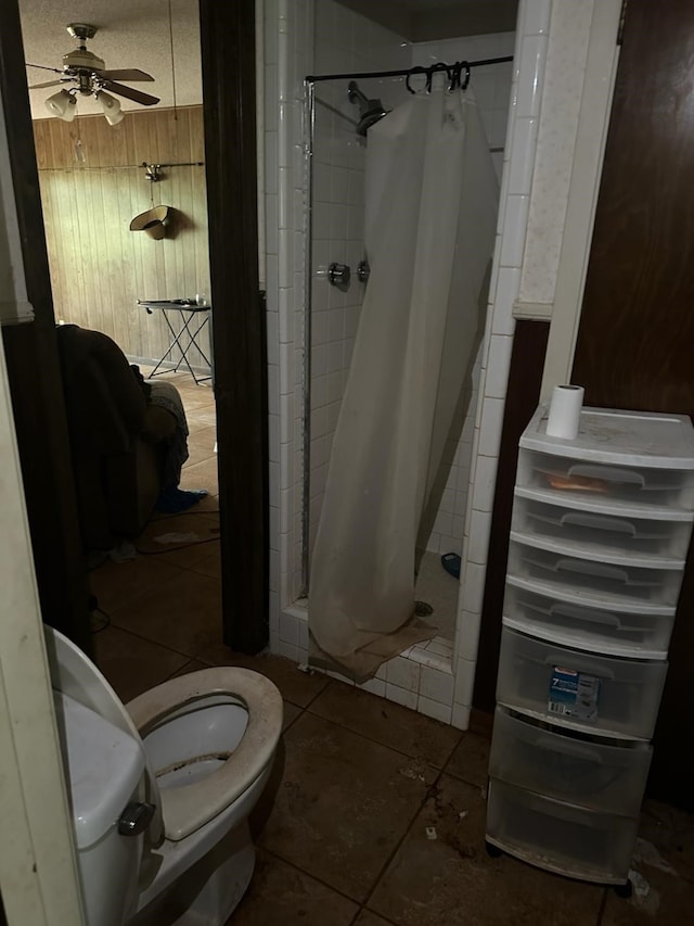 3182 E US Highway 84, Palestine, TX 75801 - bathroom featuring tile patterned flooring, a stall shower, toilet, and a ceiling fan