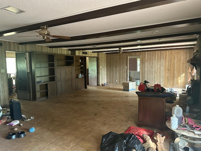 3182 E US Highway 84, Palestine, TX 75801 - miscellaneous room featuring wooden walls, beam ceiling, a ceiling fan, tile patterned floors, and plenty of natural light