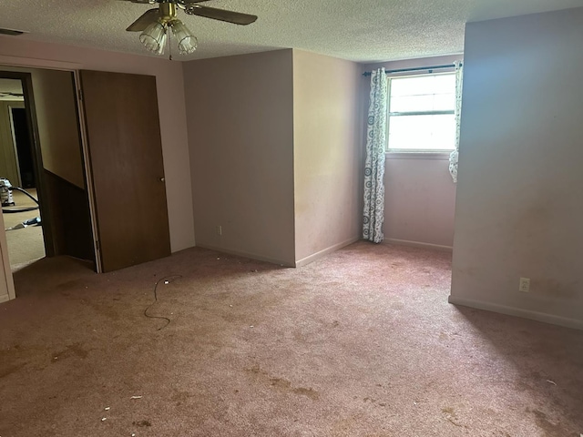 3182 E US Highway 84, Palestine, TX 75801 - carpeted spare room featuring a textured ceiling, a ceiling fan, and baseboards