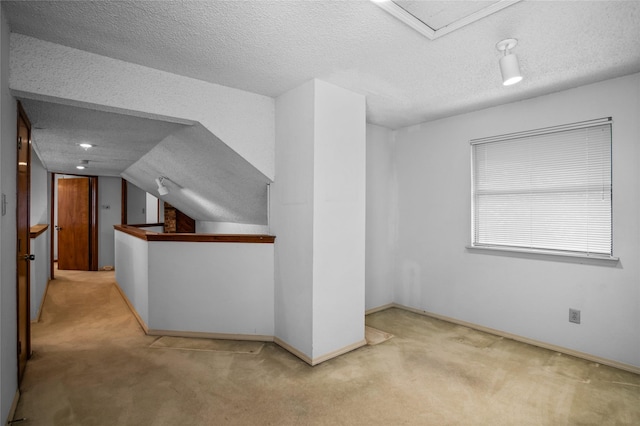 2025 Sancerre Ln, Carrollton, TX 75007 - additional living space with a textured ceiling, carpet flooring, baseboards, and vaulted ceiling