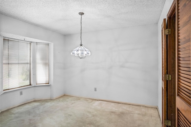 2025 Sancerre Ln, Carrollton, TX 75007 - carpeted empty room with a chandelier, a textured ceiling, and baseboards