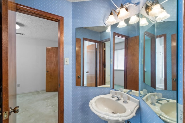 2025 Sancerre Ln, Carrollton, TX 75007 - bathroom featuring a sink and a textured ceiling