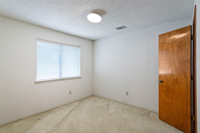 2025 Sancerre Ln, Carrollton, TX 75007 - empty room featuring a textured ceiling, carpet flooring, and baseboards