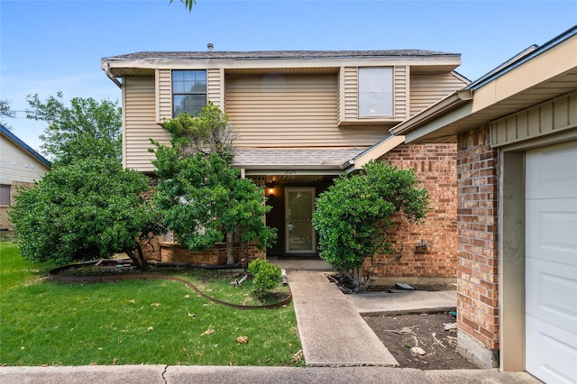 2025 Sancerre Ln, Carrollton, TX 75007 - view of front of property with a front lawn, brick siding, and a shingled roof