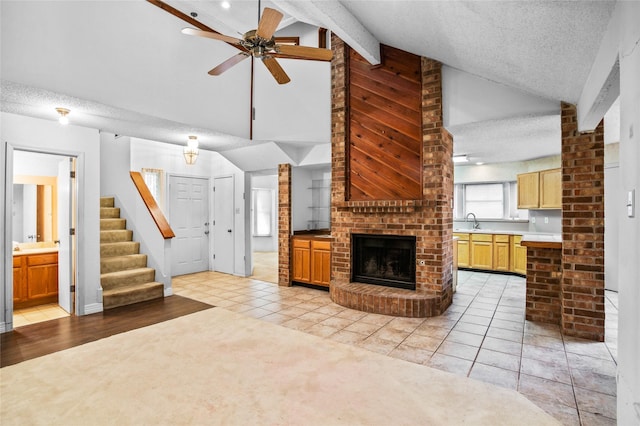 2025 Sancerre Ln, Carrollton, TX 75007 - unfurnished living room with ceiling fan, a textured ceiling, high vaulted ceiling, light tile patterned flooring, and stairway
