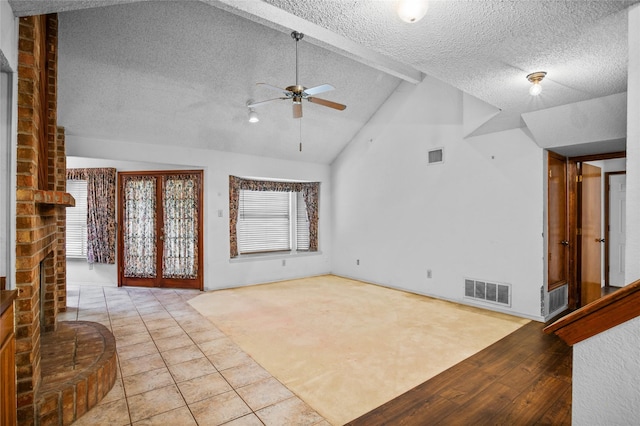 2025 Sancerre Ln, Carrollton, TX 75007 - unfurnished living room featuring ceiling fan, a textured ceiling, a fireplace, wood finished floors, and baseboards