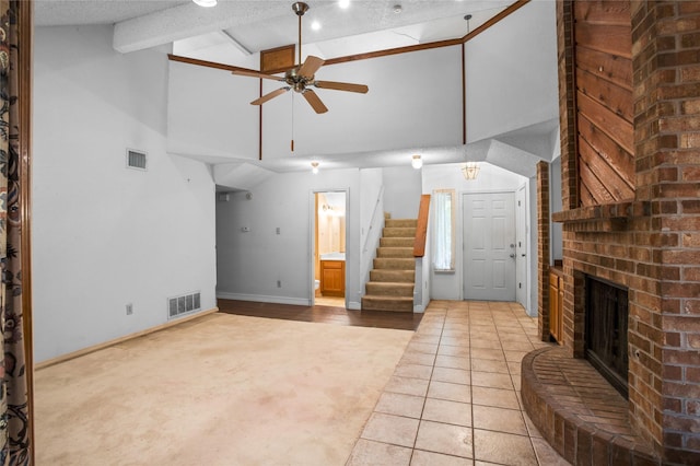 2025 Sancerre Ln, Carrollton, TX 75007 - unfurnished living room featuring light colored carpet, stairs, a ceiling fan, high vaulted ceiling, and a fireplace