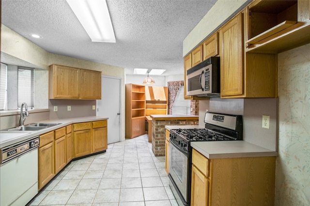 2025 Sancerre Ln, Carrollton, TX 75007 - kitchen featuring stainless steel appliances, a textured ceiling, a sink, healthy amount of natural light, and light countertops