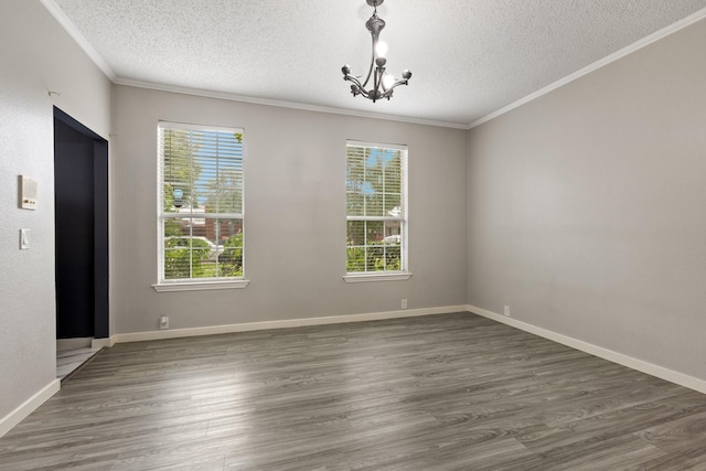 1317 Woodthorpe Dr, Mesquite, TX 75181 - unfurnished dining area with a textured ceiling, crown molding, a chandelier, wood finished floors, and baseboards