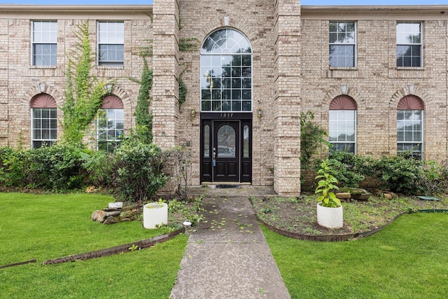 1317 Woodthorpe Dr, Mesquite, TX 75181 - property entrance with brick siding and a lawn