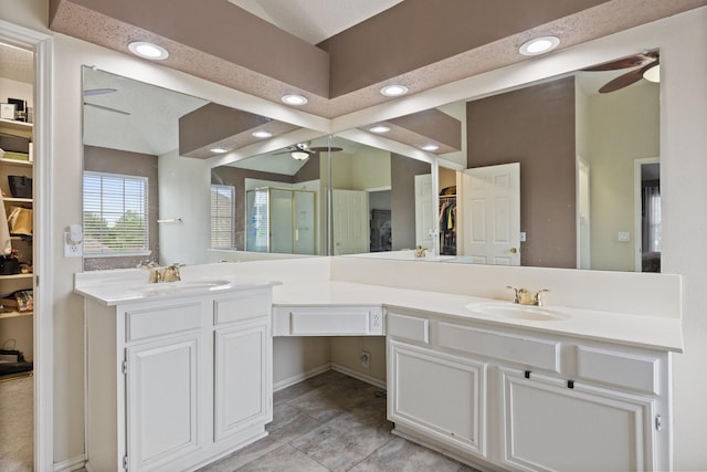 1317 Woodthorpe Dr, Mesquite, TX 75181 - bathroom featuring ceiling fan, a walk in closet, a stall shower, double vanity, and recessed lighting