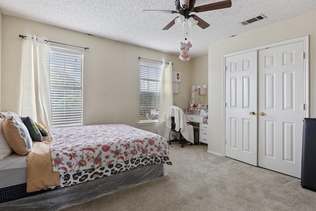 1317 Woodthorpe Dr, Mesquite, TX 75181 - carpeted bedroom with a closet, a textured ceiling, and a ceiling fan