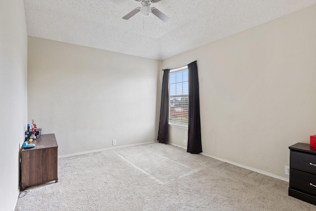 1317 Woodthorpe Dr, Mesquite, TX 75181 - spare room featuring a textured ceiling, carpet, ceiling fan, and baseboards