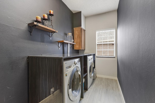 1317 Woodthorpe Dr, Mesquite, TX 75181 - washroom with washer and clothes dryer, cabinet space, light wood-type flooring, baseboards, and a textured ceiling