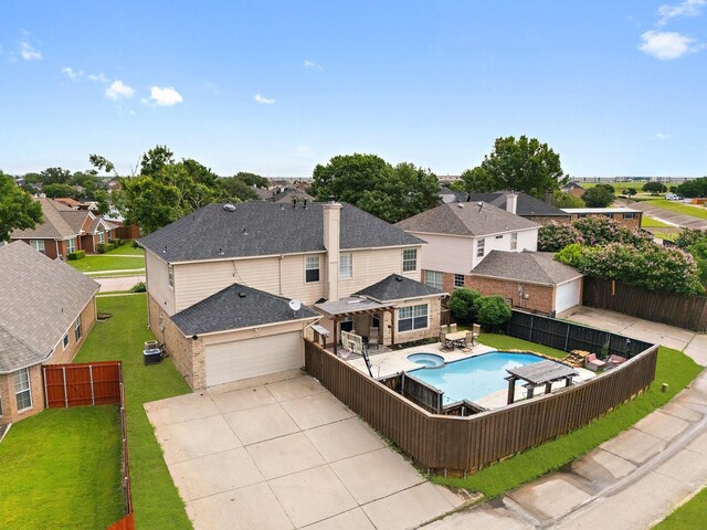 1317 Woodthorpe Dr, Mesquite, TX 75181 - view of swimming pool with a residential view, a pool with connected hot tub, and central AC