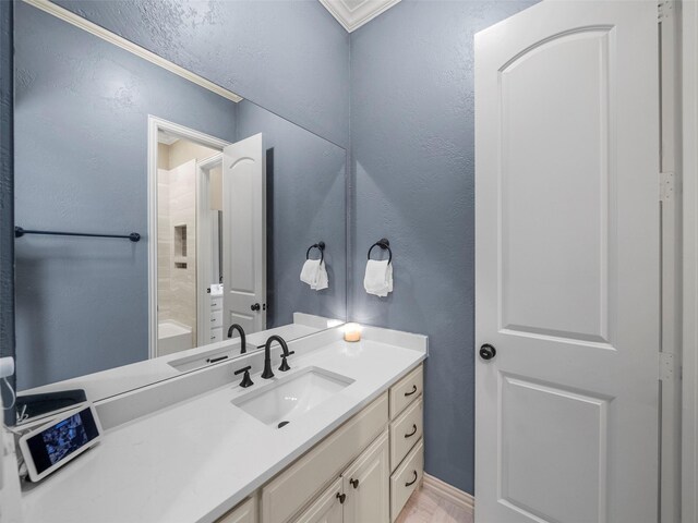 2901 Lakeview Dr, Prosper, TX 75078 - bathroom featuring vanity, ornamental molding, a textured wall, and wood finished floors