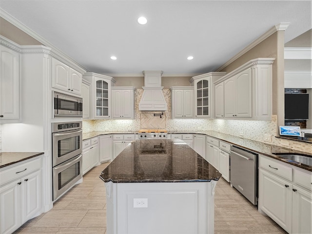 2901 Lakeview Dr, Prosper, TX 75078 - kitchen featuring stainless steel appliances, custom range hood, ornamental molding, a center island, and decorative backsplash