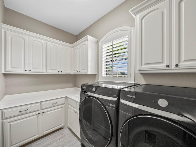 2901 Lakeview Dr, Prosper, TX 75078 - laundry area featuring washing machine and clothes dryer, cabinet space, and light wood-style flooring