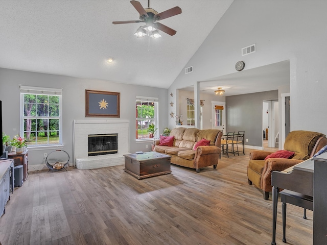 15067 Meadow Ridge Ct, Nevada, TX 75173 - living room with plenty of natural light, a ceiling fan, wood finished floors, a brick fireplace, and high vaulted ceiling