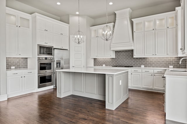 3416 Dovehill Dr, Northlake, TX 76247 - kitchen featuring a chandelier, a kitchen island, white cabinets, dark wood finished floors, and backsplash