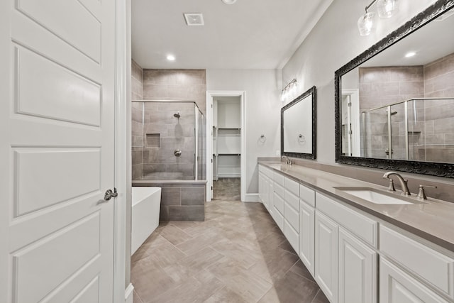 3416 Dovehill Dr, Northlake, TX 76247 - bathroom featuring a stall shower, double vanity, a tub, recessed lighting, and a spacious closet