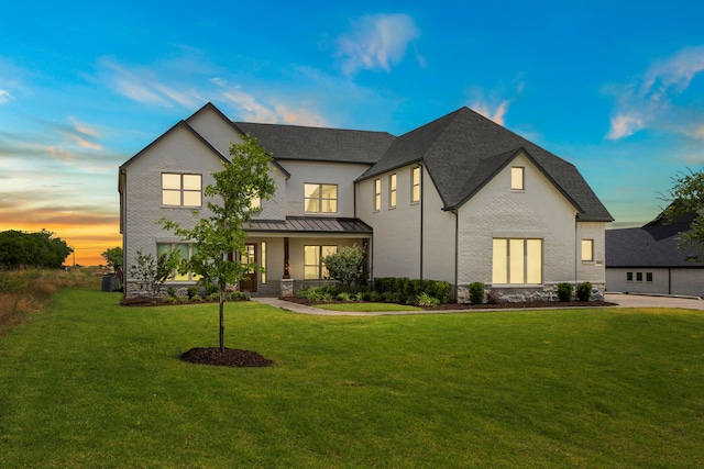3416 Dovehill Dr, Northlake, TX 76247 - view of front of home with covered porch, a yard, and a standing seam roof